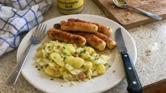 Gebratene Wollwurst mit Kartoffel-Endivien-Salat – so wird der Kartoffelsalat schön saftig